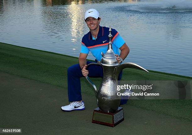 Rory McIlroy of Northern Ireland holds the trophy at the presentation after the final round of the 2015 Omega Dubai Desert Classic on the Majlis...