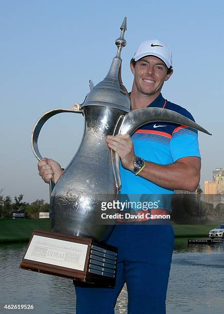 Rory McIlroy of Northern Ireland holds the trophy at the presentation after the final round of the 2015 Omega Dubai Desert Classic on the Majlis...