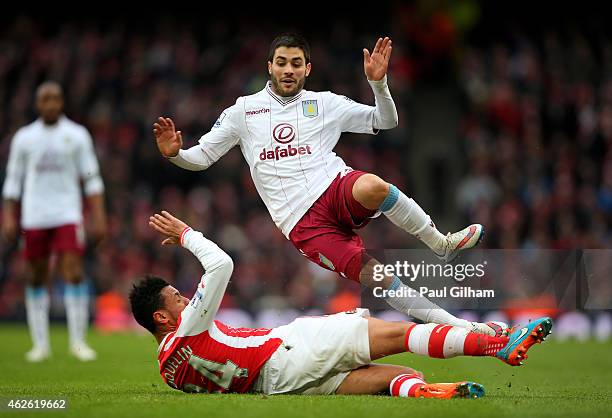 Carles Gil of Aston Villa is tackled by Francis Coquelin of Arsenal during the Barclays Premier League match between Arsenal and Aston Villa at the...