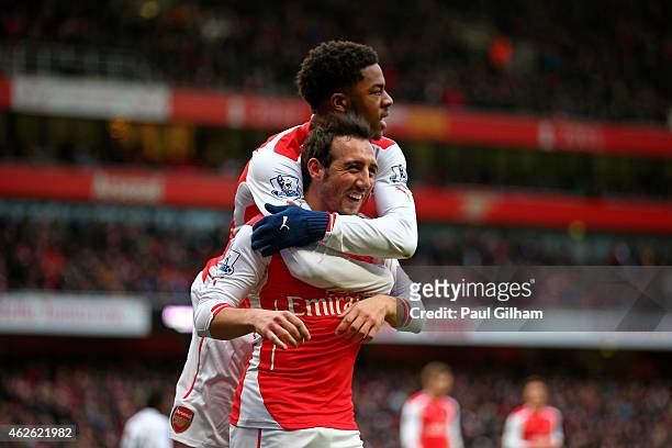 Santi Cazorla of Arsenal celebrates with teammate Chuba Akpom of Arsenal after scoring his team's fourth goal from the penalty spot during the...