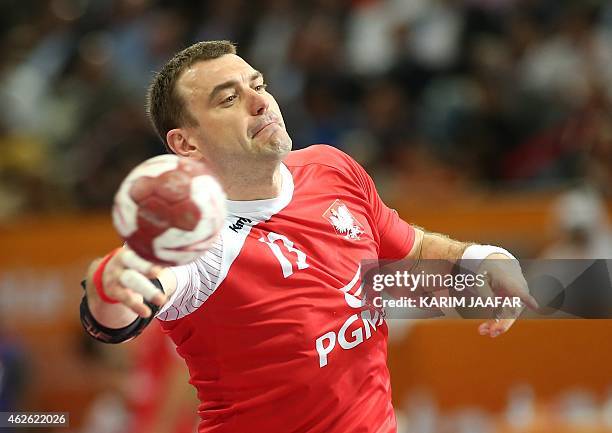 Poland's Bartosz Jurecki attempts a shot on goal during the 24th Men's Handball World Championships 3rd place match between Poland and Spain at the...