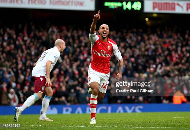 Theo Walcott of Arsenal celebrates after scoring his team's third goal during the Barclays Premier League match between Arsenal and Aston Villa at...