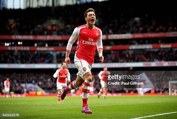 Mesut Oezil of Arsenal celebrates after scoring his team's second goal during the Barclays Premier League match between Arsenal and Aston Villa at...