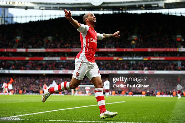 Theo Walcott of Arsenal celebrates after scoring his team's third goal during the Barclays Premier League match between Arsenal and Aston Villa at...