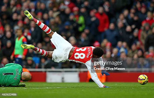 Chuba Akpom of Arsenal is brought down by goalkeeper Brad Guzan of Aston Villa to concede a penalty during the Barclays Premier League match between...