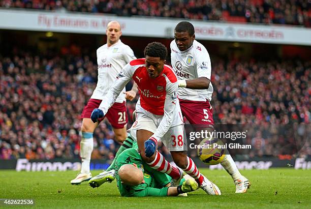 Chuba Akpom of Arsenal is brought down by goalkeeper Brad Guzan of Aston Villa to concede a penalty during the Barclays Premier League match between...