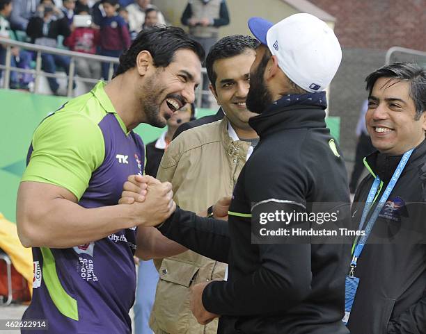 Bollywood actor John Abraham meets with Delhi Waveriders Captain Sardar Singh during a match between Delhi Waveriders and Dabang Mumbai during the...