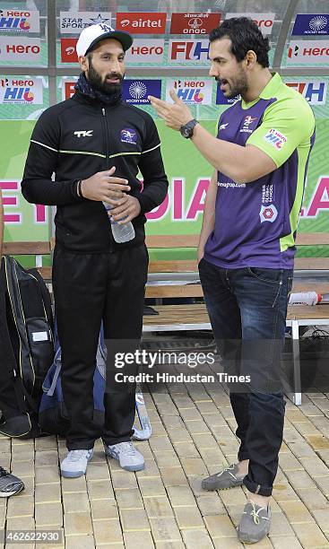 Bollywood actor John Abraham meets with Delhi Waveriders Captain Sardar Singh during a match between Delhi Waveriders and Dabang Mumbai during the...