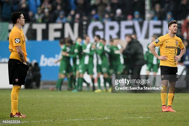 Players of Dresden react as the team of Muenster celebrates during the 3. Liga match between Preussen Muenster and Dynamo Dresden at Preussenstadion...