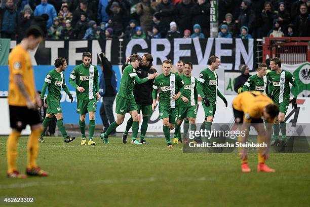 The team of Muenster celebrates their second goal as players od Dresden look dejected during the 3. Liga match between Preussen Muenster and Dynamo...