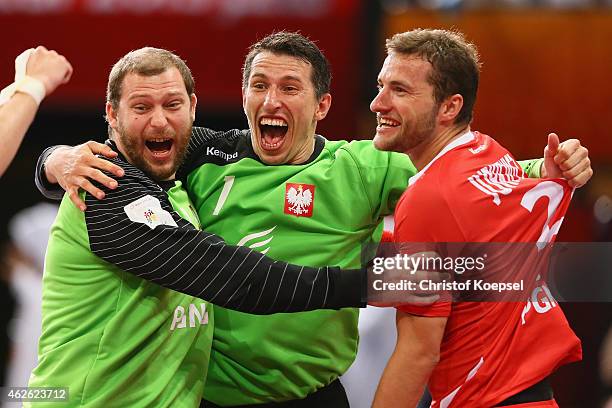 Marcin Wichary, Slawomir Szmal and Mariusz Jurkiewicz of Poland celebrate after the third place match between Poland and Spain in the Men's Handball...