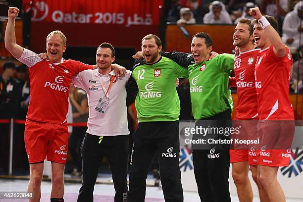 Adam Wisniewski, Marcin Wichary, Slawomir Szmal, Mariusz Jurkiewicz and Piotr Chrapkowski of Poland celebrate after the third place match between...