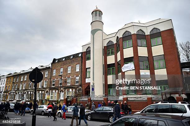 People walk past Finsbury Park Mosque during a mosques open day in London on February 1, 2015. Mosques around the UK opened their doors to the public...