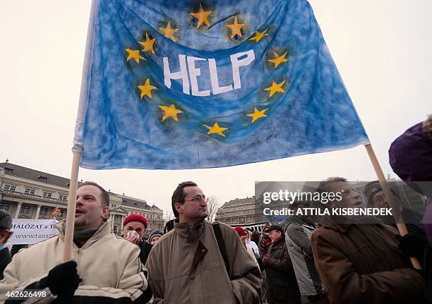 Protesters hold an EU flag in front of the building of the parliament in Budapest downtown on February 1, 2015 during their anti-government...