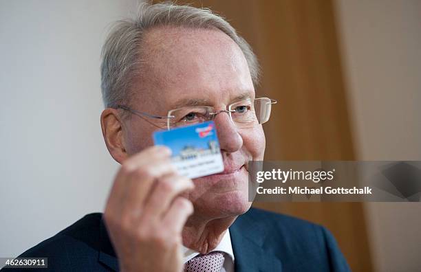 Former President of the Federation of Industry and new member of Alternative for Germany Party AFD, Hans-Olaf Henkel, shows his party member card...