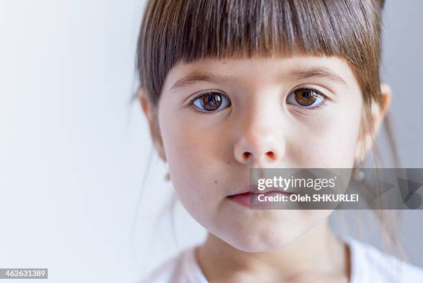 little girl looking directly into the camera - serious child stock pictures, royalty-free photos & images