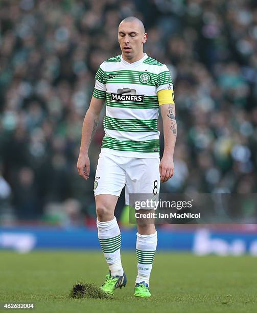 Scott Brown of Celtic looks at a damaged part of the field during the Scottish League Cup Semi-Final football match between Celtic and Rangers at...