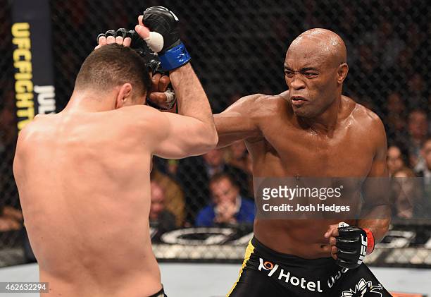Anderson Silva of Brazil punches Nick Diaz in their middleweight bout during the UFC 183 event at the MGM Grand Garden Arena on January 31, 2015 in...
