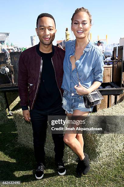 Musician John Legend and model Chrissy Teigen attend the DIRECTV Super Fan Tailgate at Pendergast Family Farm on February 1, 2015 in Glendale,...