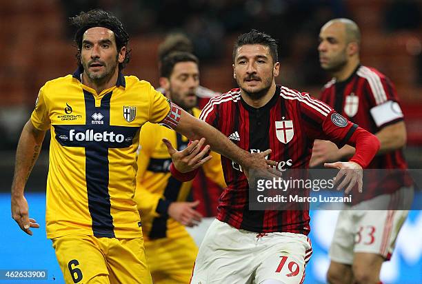 Salvatore Bocchetti of AC Milan competes with Alessandro Lucarelli of Parma FC during the Serie A match between AC Milan and Parma FC at Stadio...