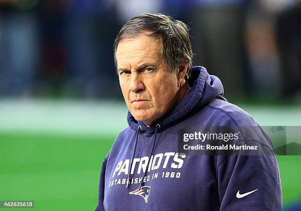 Head coach Bill Belichick of the New England Patriots stands on the field during the pregame warm up prior to playing in Super Bowl XLIX at...