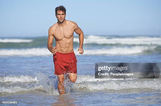 rushing back to his post - mens swimwear stock pictures, royalty-free photos & images