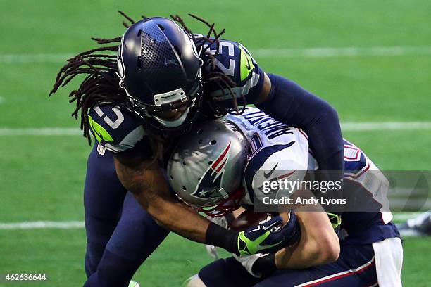 Richard Sherman of the Seattle Seahawks attempts to tackle Danny Amendola of the New England Patriots in the first quarter during Super Bowl XLIX at...