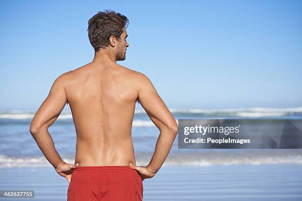 making sure that the coast is clear - men swimwear stock pictures, royalty-free photos & images