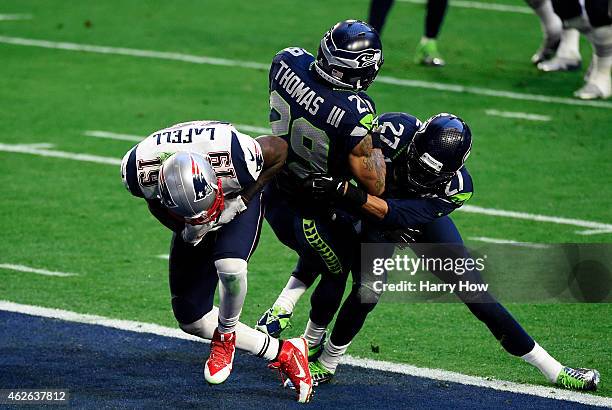 Brandon LaFell of the New England Patriots scores a touchdown over Earl Thomas and Tharold Simon of the Seattle Seahawks in the second quarter during...