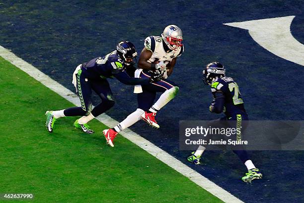 Brandon LaFell of the New England Patriots scores an 11 yard touchdown against Tharold Simon and Earl Thomas of the Seattle Seahawks in the second...