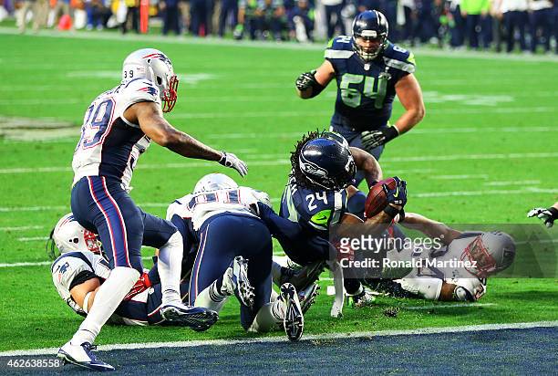 Marshawn Lynch of the Seattle Seahawks runs the ball in for a touchdown against the New England Patriots in the second quarter during Super Bowl XLIX...