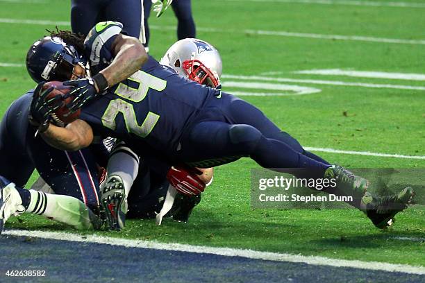 Marshawn Lynch of the Seattle Seahawks scores a three yard touchdown in the second quarter against the New England Patriots during Super Bowl XLIX at...
