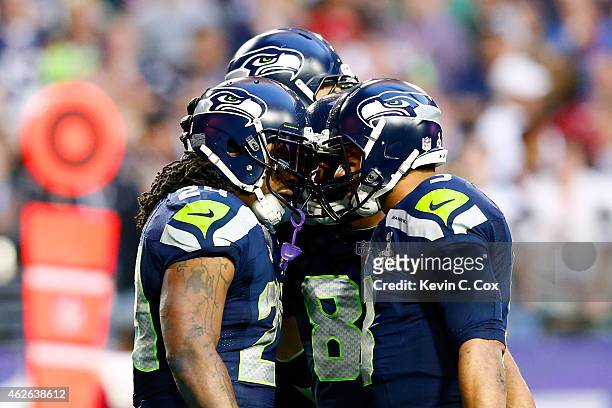 Marshawn Lynch and Russell Wilson of the Seattle Seahawks celebrate after a three yard touchdown by Lynch in the second quarter against the New...