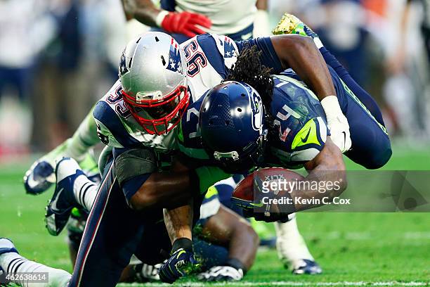 Marshawn Lynch of the Seattle Seahawks is tackled by Chandler Jones of the New England Patriots in the second quarter during Super Bowl XLIX at...