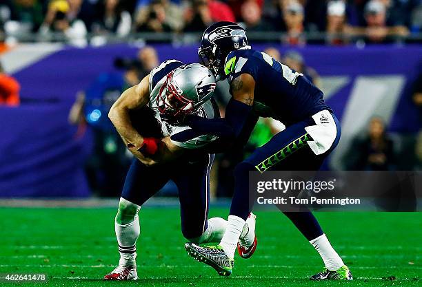 Julian Edelman of the New England Patriots catches a pass over Tharold Simon of the Seattle Seahawks in the third quarter during Super Bowl XLIX at...