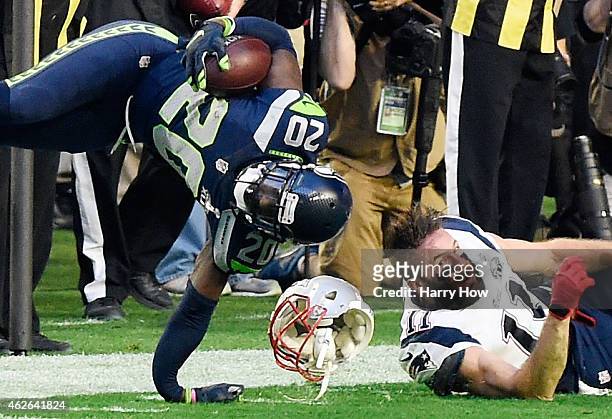 Jeremy Lane of the Seattle Seahawks breaks his arm after an interception as he is tackled by Julian Edelman of the New England Patriots in the first...