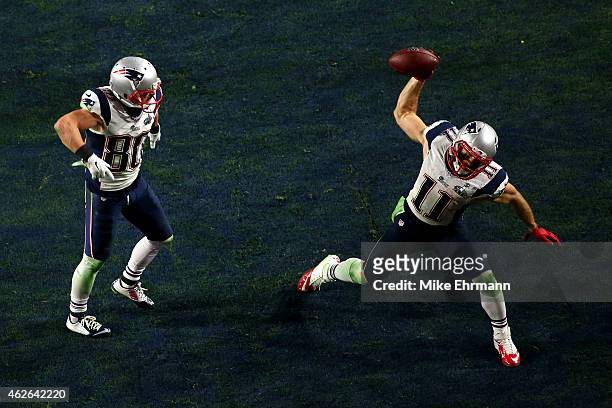Julian Edelman of the New England Patriots celebrates scoring on a three yard touchdown pass as Danny Amendola looks on in the fourth quarter against...