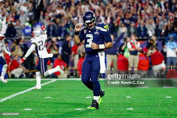 Russell Wilson of the Seattle Seahawks reacts after an interception in the fourth quarter against the New England Patriots during Super Bowl XLIX at...