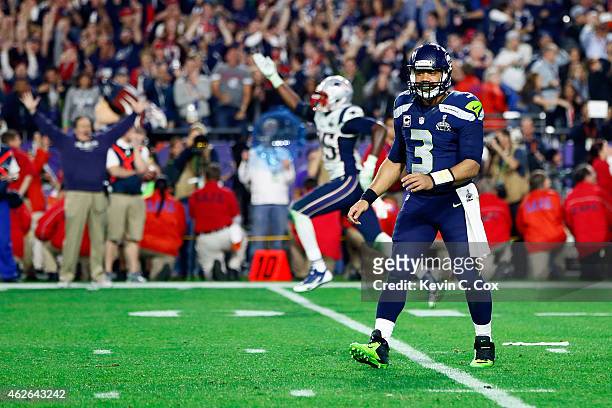 Russell Wilson of the Seattle Seahawks looks on after his pass is intercepted by Malcolm Butler of the New England Patriots late in the fourth...