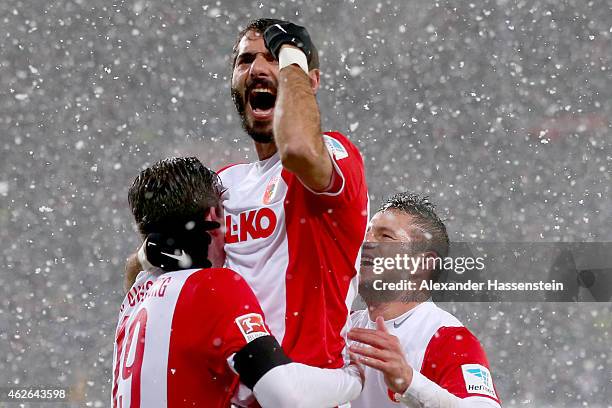 Halil Altintop of Augsburg celebrates his team's first goal with team mates Pierre-Emile Hojbjerg and Raul Bobadilla during the Bundesliga match...