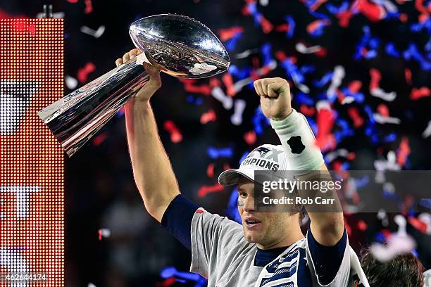 Tom Brady of the New England Patriots celebrates with the Vince Lombardi Trophy after defeating the Seattle Seahawks during Super Bowl XLIX at...