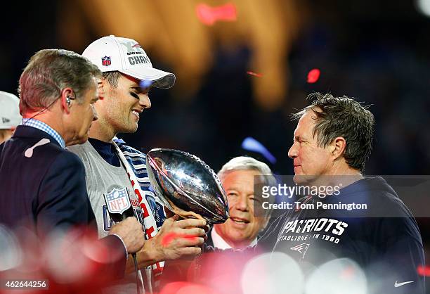 Tom Brady, team owner Robert Kraft, and head coach Bill Belichick of the New England Patriots celebrate with the Vince Lombardi Trophy after...