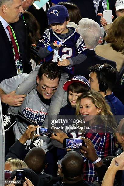 Tom Brady of the New England Patriots celebrates defeating the Seattle Seahawks with his wife Gisele Bundchen and son Benjamin during Super Bowl XLIX...