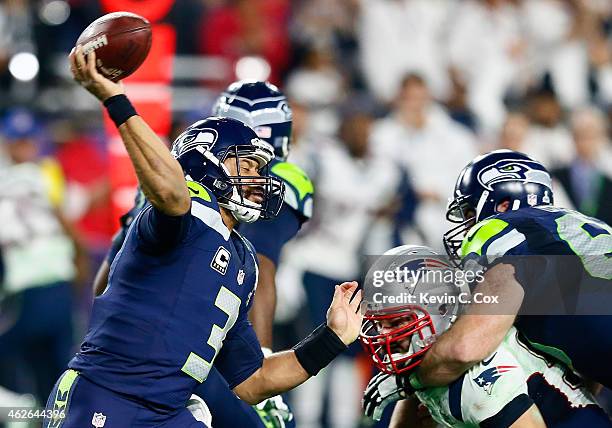 Russell Wilson of the Seattle Seahawks has a pass intercepted by Malcolm Butler of the New England Patriots late in the fourth quarter against the...