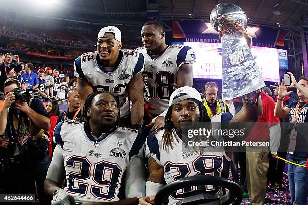 LeGarrette Blount, Brandon Bolden, Darius Fleming and Ryan Wendell celebrate with the Vince Lombardi Trophy after defeating the Seattle Seahawks...