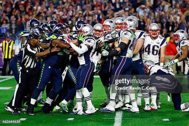 Matthew Slater of the New England Patriots and Demarcus Dobbs of the Seattle Seahawks clash in the fourth quarter during Super Bowl XLIX at...