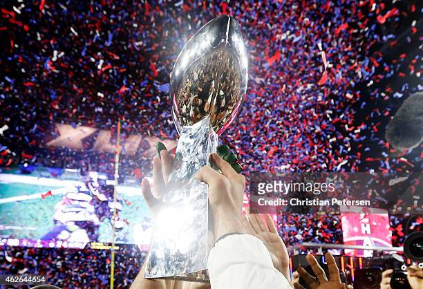 Members of the New England Patriots celebrate with the Vince Lombardi Trophy after defeating the Seattle Seahawks 28-24 in Super Bowl XLIX at...