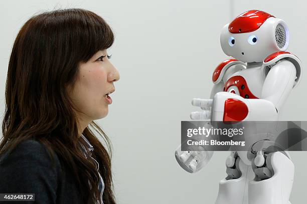 Bank of Tokyo Mitsubishi UFJ Ltd. Employee speaks to a NAO humanoid robot, developed by Softbank Corp. Subsidiary Aldebaran Robotics SA, performing...