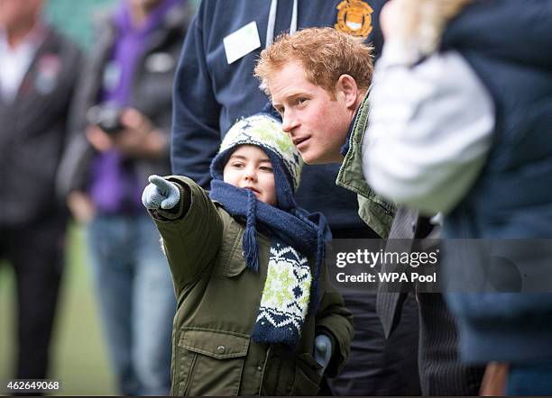 Prince Harry with Harrison Hogg while watching a training session for RFU Injured Players Foundation runners taking part in this year's London...