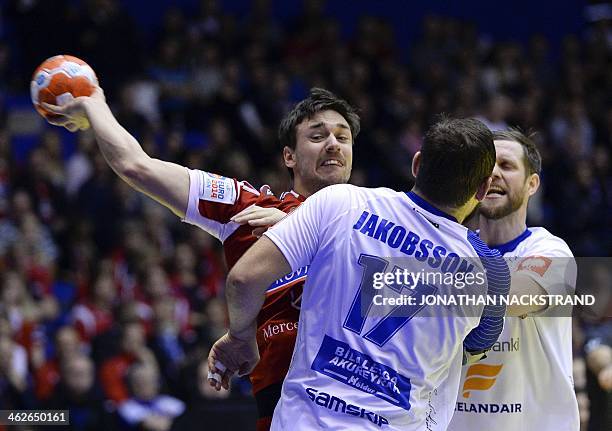 Hungary's centre back Mate Lekai vies with Iceland's pivot Sverre Jakobsson and pivot Vignir Svavarsson during the men's EHF Euro 2014 Handball...